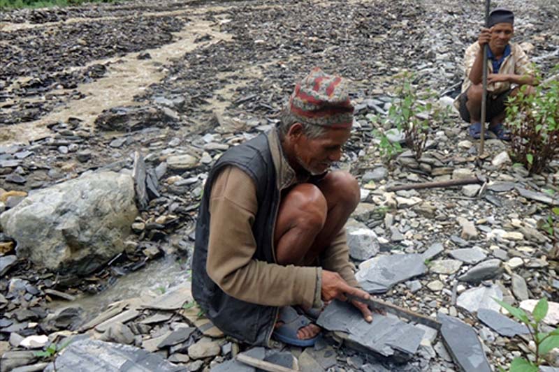 A 57-year-old Aaitram Sunar  of Gajul-3 in Libang of Rolpa district crushes stones for his hand-to-mouth existence near the Khumelgadh stream, on Monday, October 24, 2016. Photo: RSS