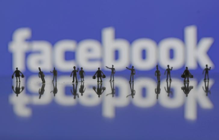 3D-printed models of people are seen in front of a Facebook logo in this photo illustration taken June 9, 2016. REUTERS/Dado Ruvic/Illustration/Files