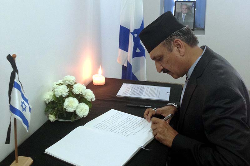 Foreign Affairs Minister Prakash Sharan Mahat signs a book of condolences on the death of Shimon Peres, former President of Israel, at the Embassy of Israel in Kathmandu, on Wednesday, October 5, 2016. Photo: RSS