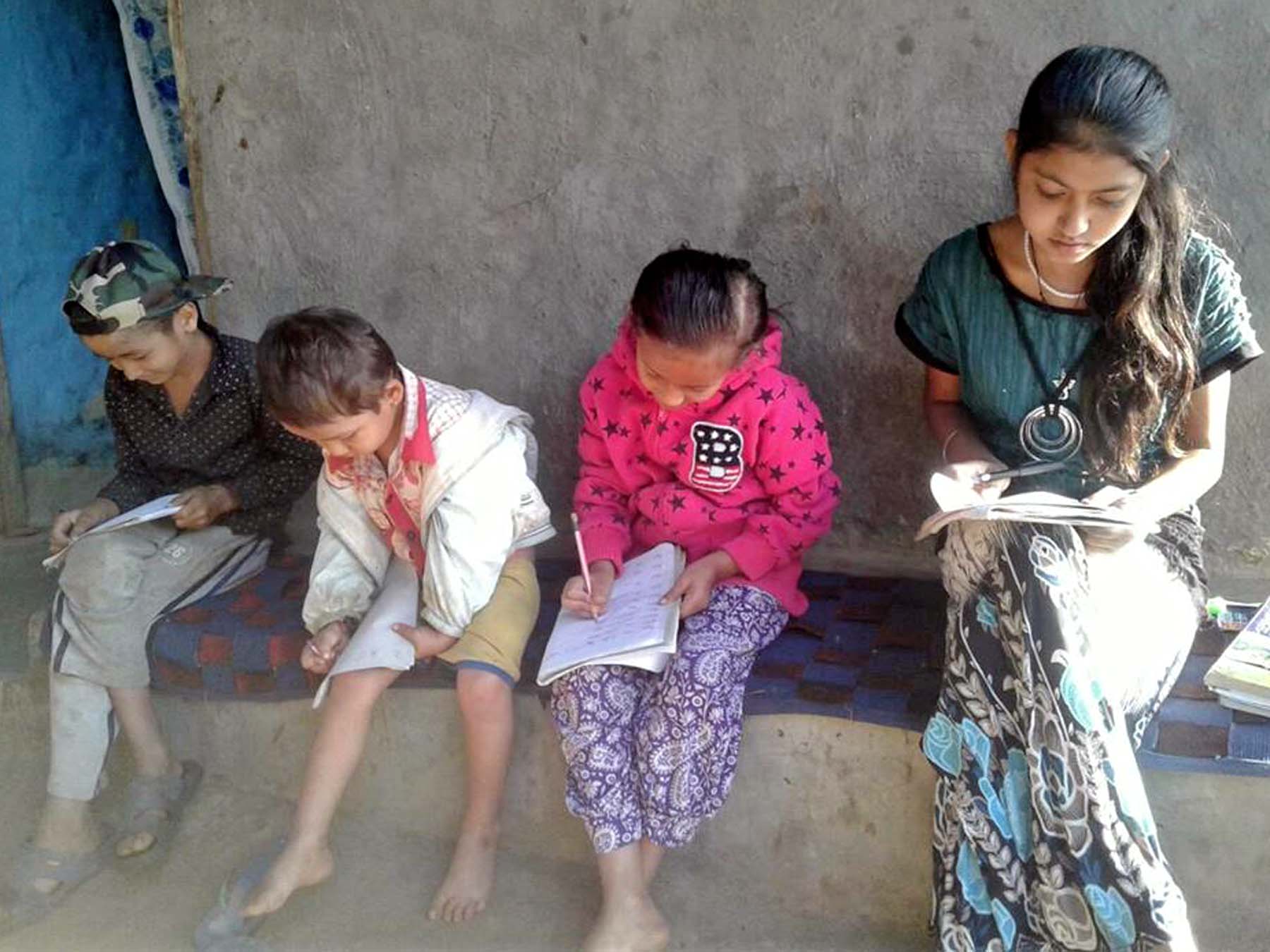 Students doing homework during their Dashain-Tihar vacation, in Dang district, on Sunday, October 23, 2016. Photo: RSS