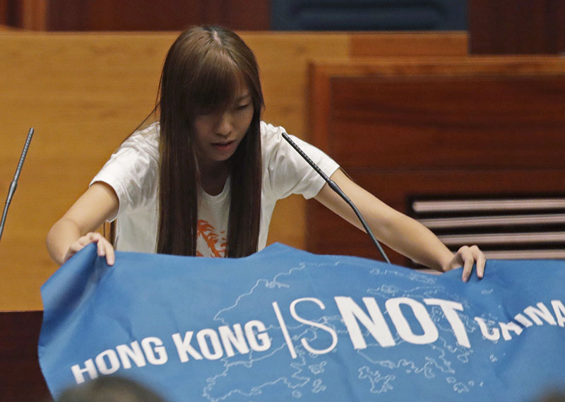 Newly elected lawmaker Yau Wai-ching of Youngspiration displays a banner with words reading u201cHong Kong is not Chinau201d as she takes oath in the new legislature Council in Hong Kong, on Wednesday, October 12, 2016. Photo: AP