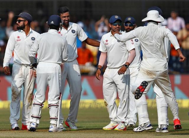 India's Ravichandran Ashwin celebrates with teammates after the wicket of New Zealand's James Neesham. REUTERS/Danish Siddiqui