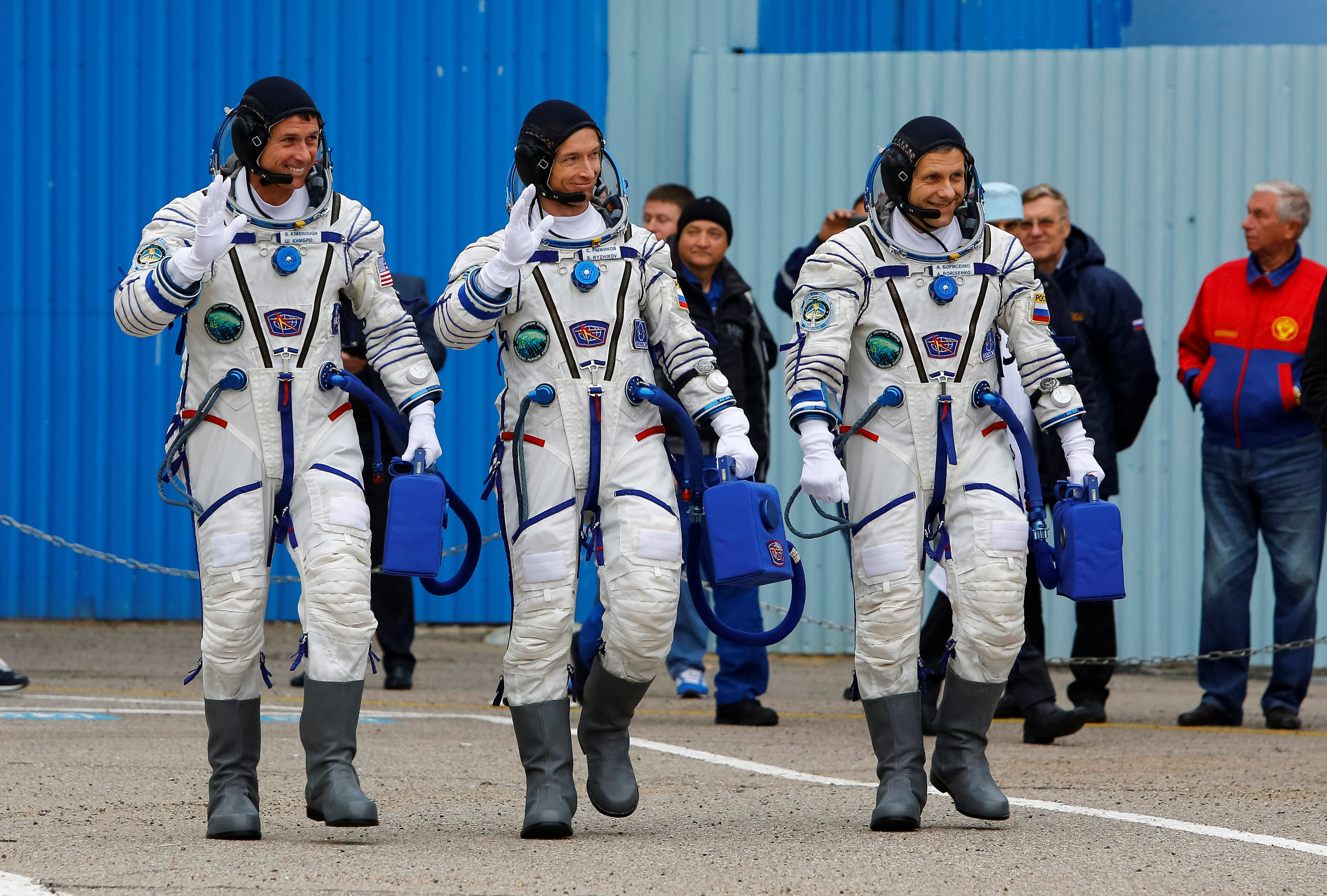 The International Space Station (ISS) crew members (L to R)Shane Kimbrough of the U.S., Sergey Ryzhikov and Andrey Borisenko of Russia walk after donning space suits at the Baikonur cosmodrome, Kazakhstan, October 19, 2016.  REUTERS/Shamil Zhumatov