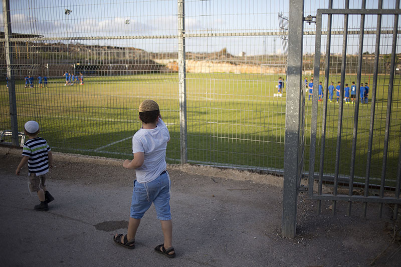 FILE: Jewish settler children watch a soccer training session of the Beitar Shabi Givat Zeev soccer club in the West Bank Jewish settlement of Givat Zeev, near Jerusalem, on September 22, 2016. Photo: AP