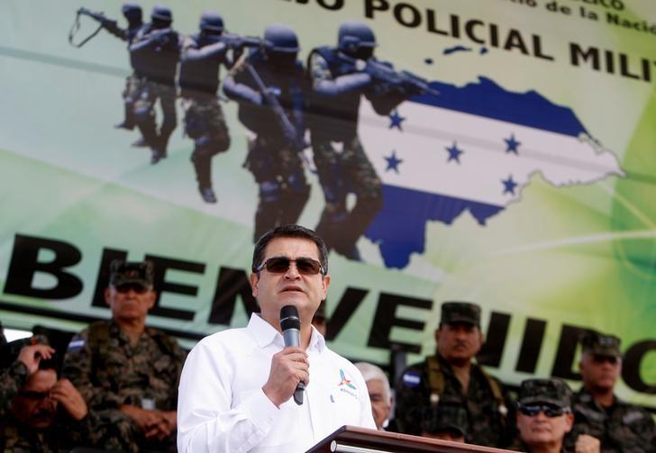 Honduran President Juan Orlando Hernandez gives a speech next to members of the Military Police for Public Order in a ceremony to celebrate the third anniversary of the creation of the Military Police, in Tegucigalpa, Honduras August 24, 2016. REUTERS/Jorge Cabrera/File Photo
