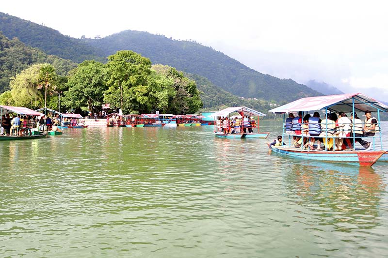 Locals travel to the Talbarahi Temple on boats with the onset of Talbarahi fair in Pokhara of Kaski district on Saturday, October 15, 2016. Photo: RSS