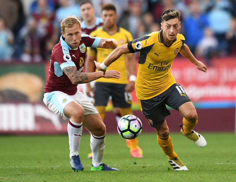 Arsenal's Mesut Ozil in action with Burnley's Scott Arfield. Photo: Reuters