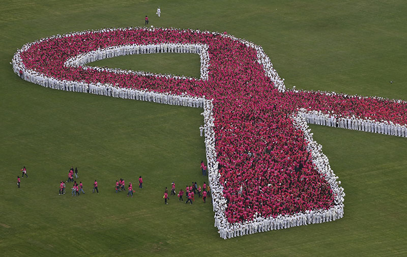 Participants begin to break away after helping form a giant pink ribbon to mark the start of breast cancer awareness month, inside the grounds of a military camp in Mexico City, on Saturday, October 1, 2016. Photo: AP