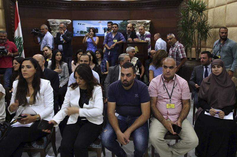 Journalists watch the election of a new president on  TV, ahead of the arrival by Christian leader Michel Aoun, the assumed president elect, at the Presidential Palace in Baabda, east of Beirut, Lebanon, Monday, October 31, 2016. Photo: AP