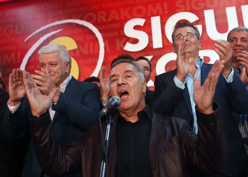 Montenegro's Prime Minister and long-ruling Democratic Party of Socialists leader Milo Djukanovic (C) speaks in his party headquarters, in Podgorica, Montenegro, on October 17, 2016. Photo: AP