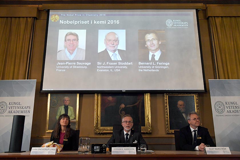 The Royal Academy of Sciences members present 2016 Nobel Chemistry Prize during a news conference by the Royal Swedish Academy of Sciences in Stockholm, Sweden October 5, 2016. The winners of the 2016 Nobel Chemistry Prize (L-R) Jean-Pierre Sauvage, J Fraser Stoddart and Bernard L Feringa are displayed on a screen. TT News Agency/Henrik Montgomery/via Reuters