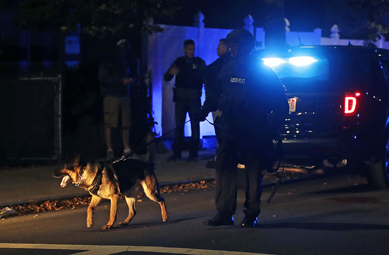 Police search for a suspect after a shooting in the East Boston neighborhood of Boston, on Wednesday, October 12, 2016. Photo: AP