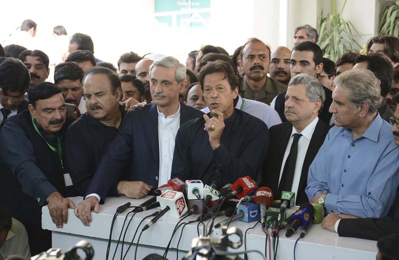 Pakistan's cricketer turned politician Imran Khan (C) talks to journalists outside the Supreme Court in Islamabad, Pakistan, on October 20, 2016. Photo: AP