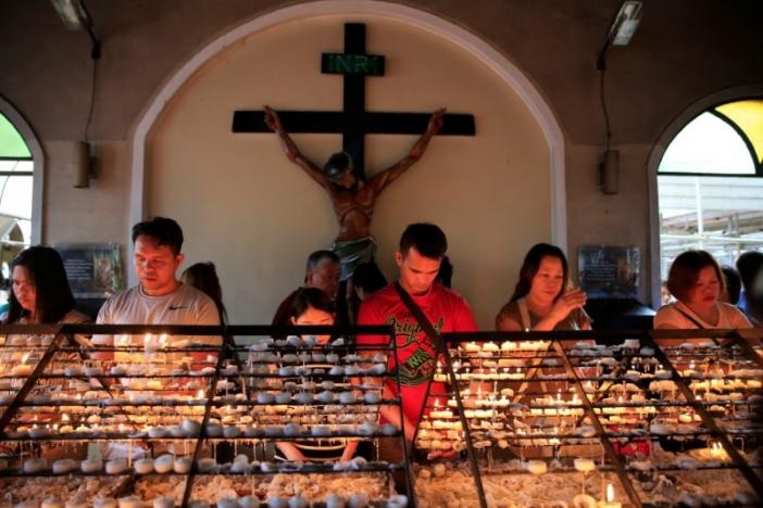 Filipino Catholic devotees light candles and offer prayers after attending a mass at a National Shrine of Our Mother of Perpetual Help in Baclaran, Paranaque city, metro Manila, Philippines on September 18, 2016. Photo: Reuters