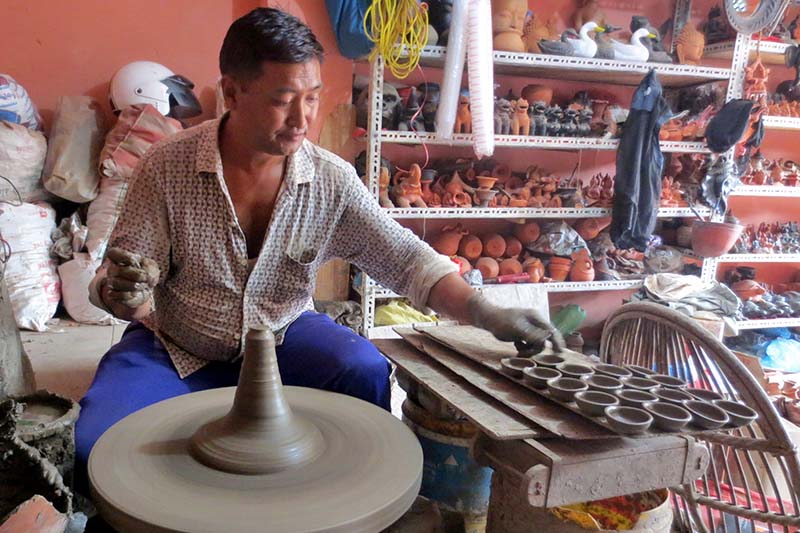 A pottery maker makes butter lamps (diyos) for the upcoming Tihar festival, at the Pottery Square in Bolachhe of Bhaktapur district on Tuesday, October 25, 2016. Tihar is also known as the festival of lights. Photo: RSS