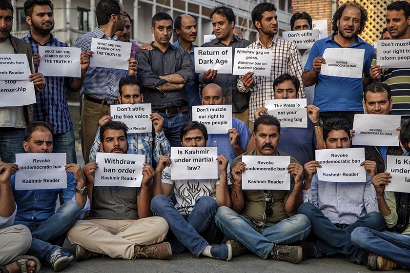Kashmiri journalists hold placards during a protest in Srinagar, Indian controlled Kashmir, Tuesday, Oct. 4, 2016. Authorities in Indian-controlled Kashmir have banned the publication of a local newspaper, saying that its contents could incite violence in the disputed Himalayan region. AP Photo/Dar Yasin