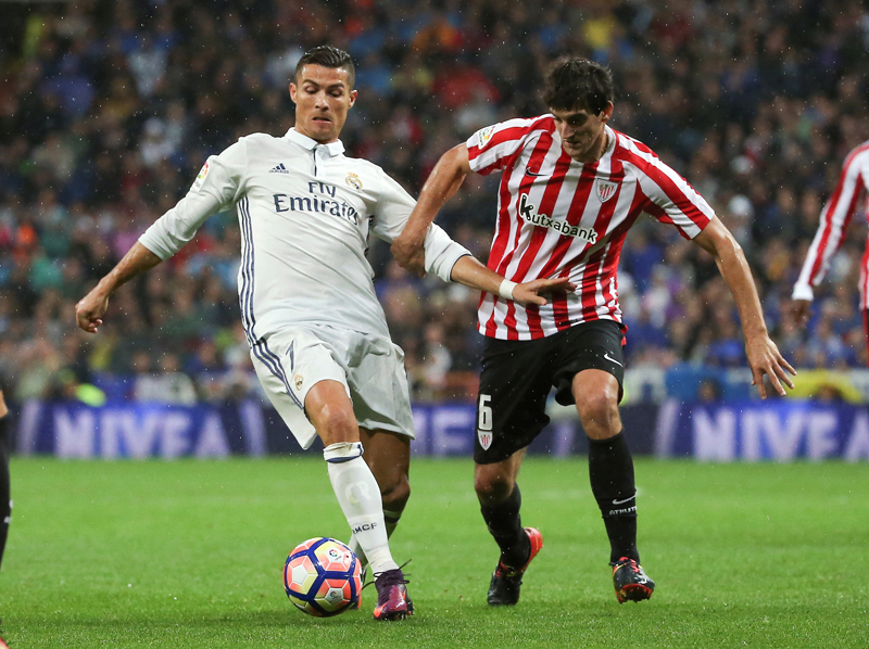 Real Madrid's Cristiano Ronaldo and Athletic Bilbao's Mikel San Jose in action. Photo: Reuters