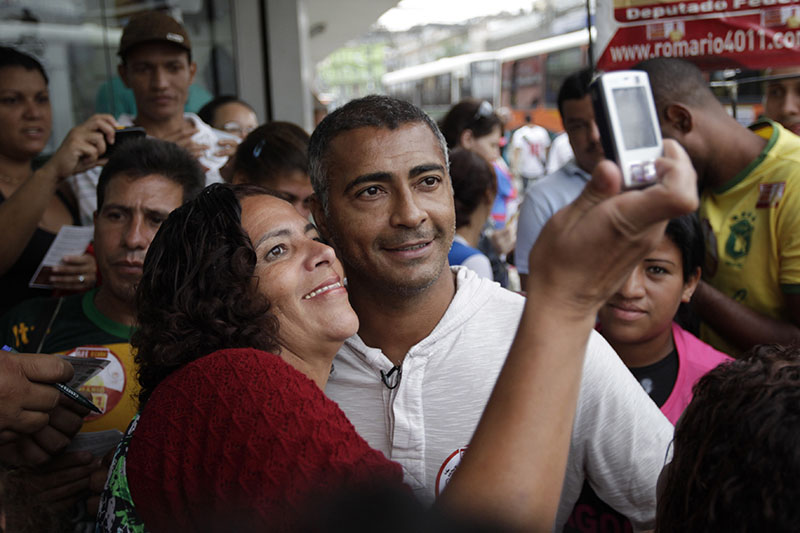 FILE - Brazil's former soccer great and candidate for the Federal Congress, Romario (centre) is pictured by a supporter as he campaigns in Sao Joao de Meriti, Rio de Janeiro State, Brazil, on September 29, 2010. Photo: AP