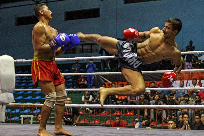 Rupak Nepali (right) of Pokhara kicks on the chest of Tribhuvan Army Club's Chitra Singh Thakuri during their menu2019s 70kg weight category final bout of the First K Bag Muay Thai Championship in Kathmandu on Saturday, October 1, 2016. Photo: THT
