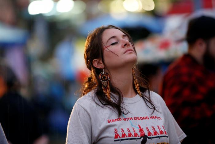 Actor Shailene Woodley closes her eyes as rain falls during a prayer circle at a climate change rally in solidarity with protests of the pipeline in North Dakota at MacArthur Park in Los Angeles, California October 23, 2016. REUTERS/Patrick T. Fallon