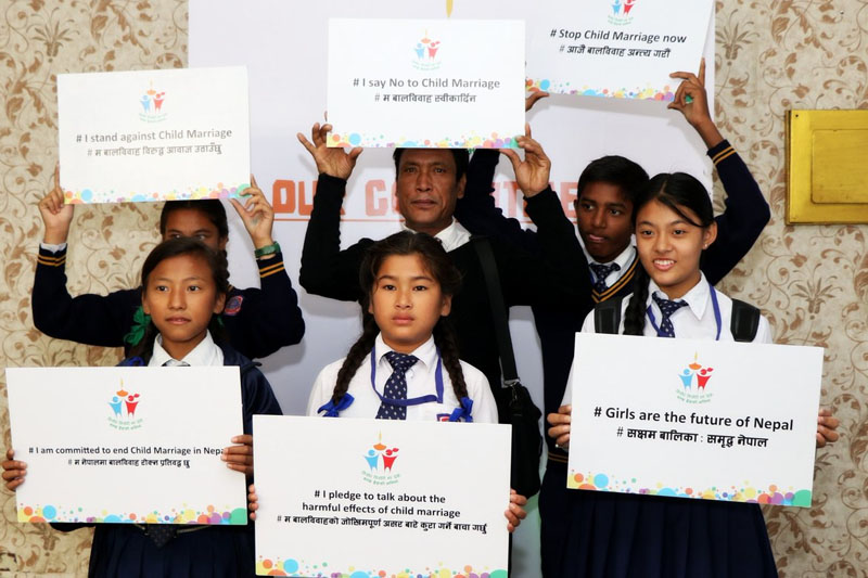 Children show placards calling to invest in girls for the future of Nepal at an event organised to mark the International Day of the Girl Child, in Lalitpur, on Sunday, October 23, 2016. Photo: IDGCNepal2016/Twitter