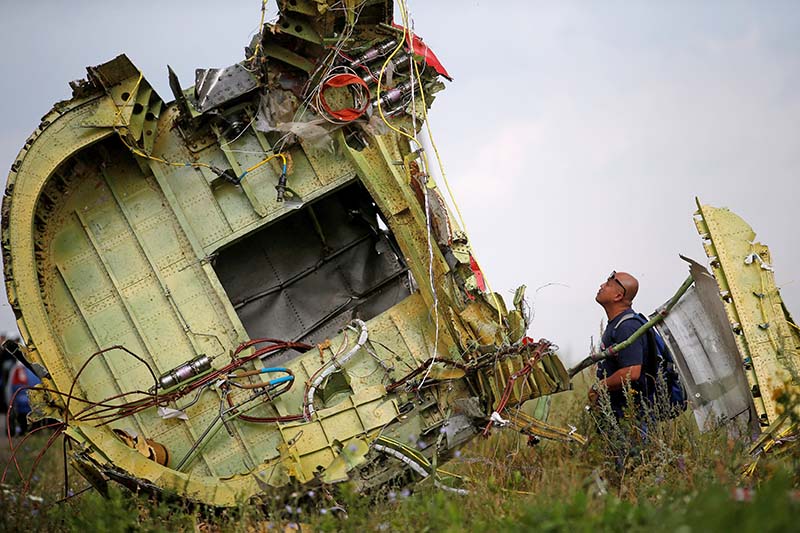 A Malaysian air crash investigator inspects the crash site of Malaysia Airlines Flight MH17, near the village of Hrabove (Grabovo) in Donetsk region, Ukraine, on July 22, 2014. Photo: Reuters/ File