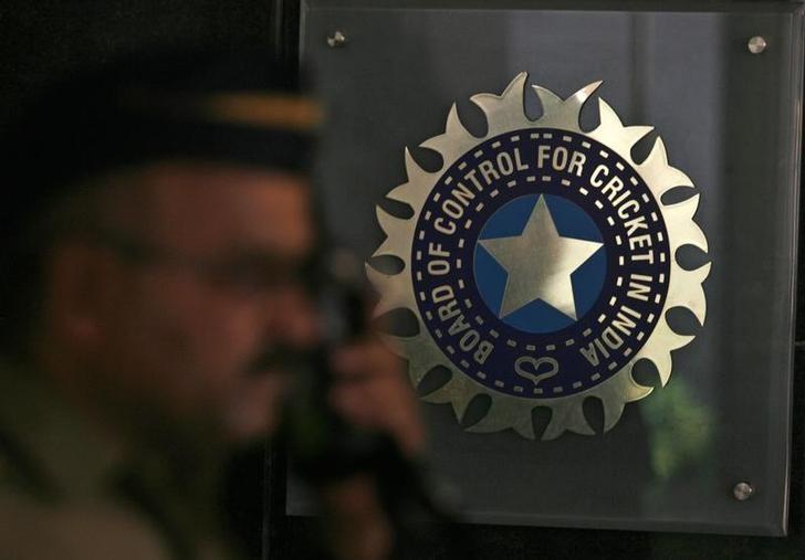 A policeman walks past a logo of the Board of Control for Cricket in India (BCCI) during a governing council meeting of the Indian Premier League (IPL) at BCCI headquarters in Mumbai April 26, 2010. REUTERS/Arko Datta/Files