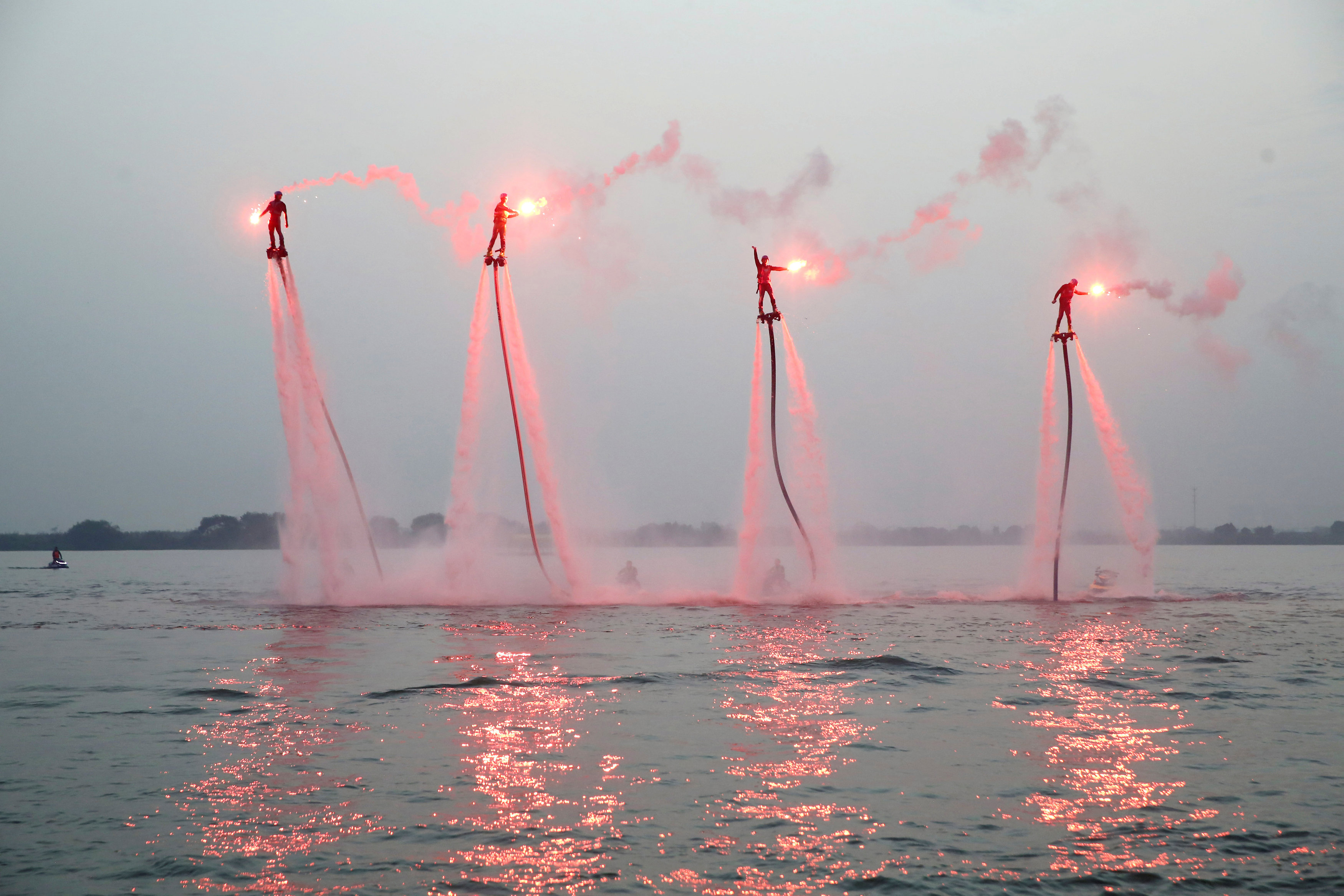 People riding on water-powered jet-boards perform in Yixing, Jiangsu province, China, October 17, 2016. Picture taken October 17, 2016. REUTERS/Stringer ATTENTION EDITORS - THIS IMAGE WAS PROVIDED BY A THIRD PARTY. EDITORIAL USE ONLY. CHINA OUT. NO COMMERCIAL OR EDITORIAL SALES IN CHINA.