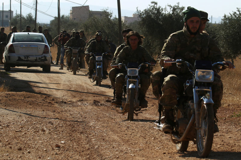 Rebel fighters drive their motorcycles, western Aleppo city, Syria, on November 3, 2016. Photo: Reuters