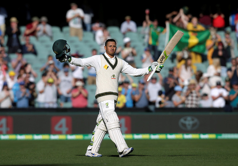 Australian batsman Usman Khawaja celebrates scoring his 100 runs century during the second day of the Third Test cricket match in Adelaide. Photo: Reuters