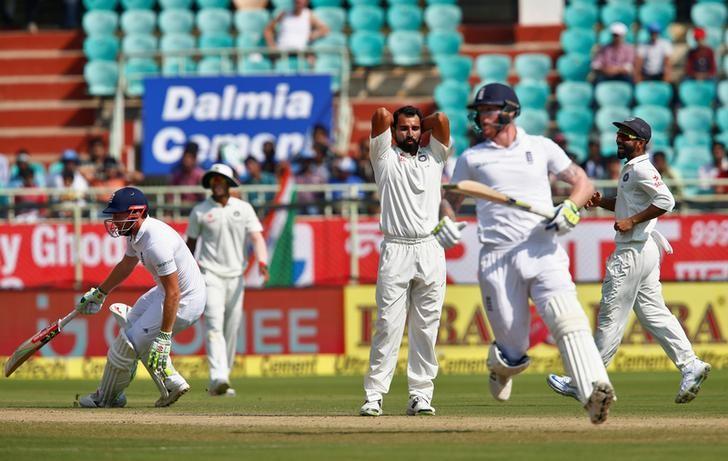 Cricket - India v England - Second Test cricket match - Dr. Y.S. Rajasekhara Reddy ACA-VDCA Cricket Stadium, Visakhapatnam, India - 19/11/16. India's Mohammed Shami (3rd R) reacts as England's Ben Stokes (2nd R) and Jonny Bairstow (L) run between wicket. REUTERS/Danish Siddiqui