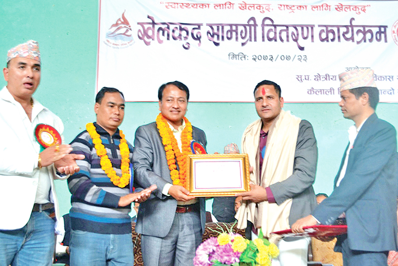 NSC Member Secretary Keshab Kumar Bista handing over the felicitation letter to Deepak Bista (second from right) in Dhangadhi on Tuesday, November 8, 2016. Photo: THT