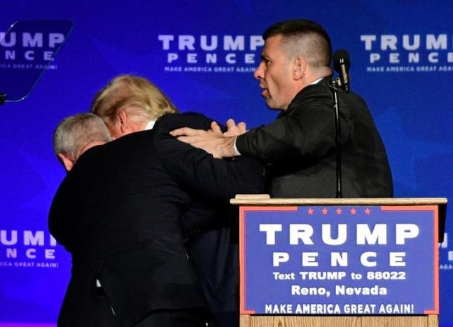 U.S. Republican presidential nominee Donald Trump is hustled off the stage by security agents after a perceived threat in the crowd, at a campaign rally in Reno, Nevada, U.S. November 5, 2016. REUTERS/Steven Styles