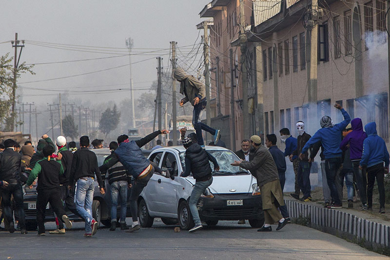 Kashmiri protesters smash windshields of private cars for ignoring separatist-sponsored strike during the funeral of Qaiser Sofi in Srinagar, Indian controlled Kashmir on Saturday, November 5, 2016.Photo: AP