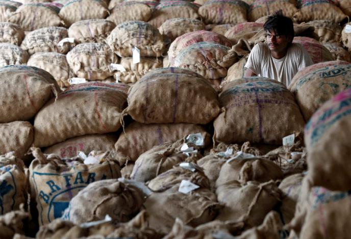 A labourer sits amongst sacks of unsold potatoes at a wholesale market in Manchar village in the western state of Maharashtra, India, November 16, 2016. REUTERS/Shailesh Andrade