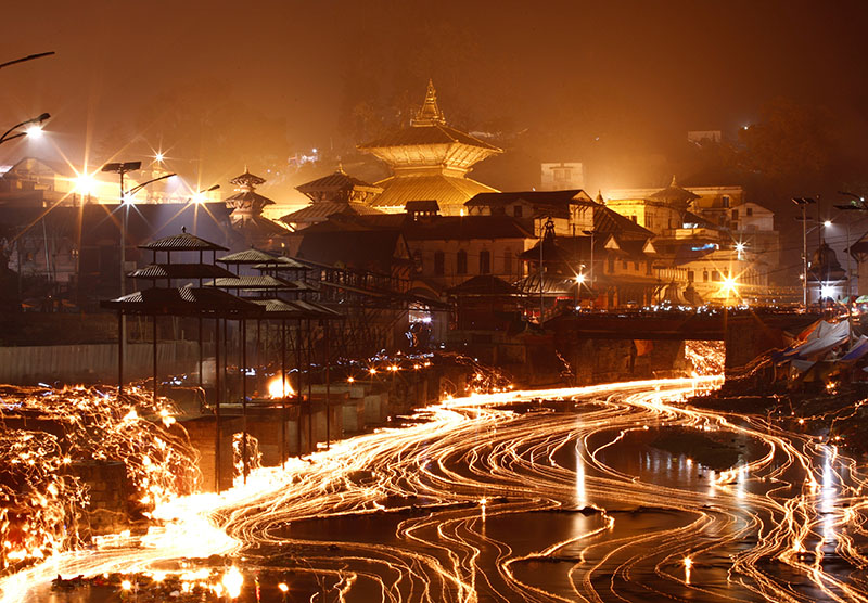 Oil lamps offered by devotees illuminate the Bagmati River flowing through the premises of the Pashupatinath Temple during the Bala Chaturdashi festival in Kathmandu, on Monday, November 28, 2016. Photo: REUTERS