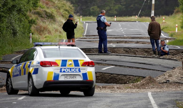 Policemen and locals look at damage following an earthquake, along State Highway One near the town of Ward, south of Blenheim on New Zealand's South Island, November 14, 2016. REUTERS/Anthony Phelps