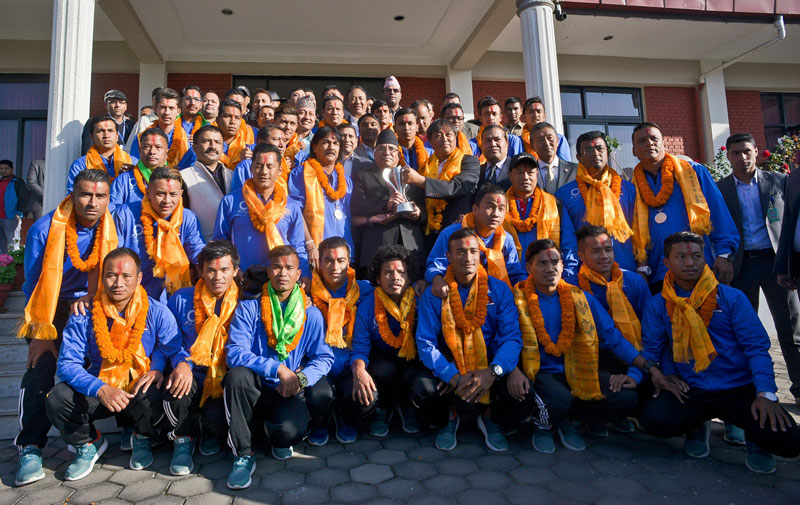 Nepal national football team members pose for a group photo with Prime Minister Pushpa Kamal Dahal (centre) and other officials after being felicitated for winning the AFC Solidarity Cup at the PMu2019s residence in Kathmandu on Thursday. Photo courtesy: ANFA