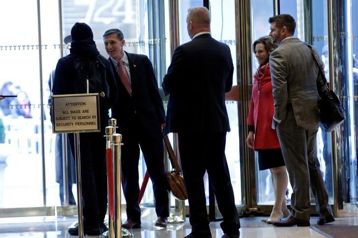 Retired U.S. Army Lieutenant General Michael Flynn (2nd L) greets people in the lobby as he departs after meeting with U.S. President-elect Donald Trump at Trump Tower in New York City, NY, U.S. November 18, 2016. REUTERS/Mike Segar