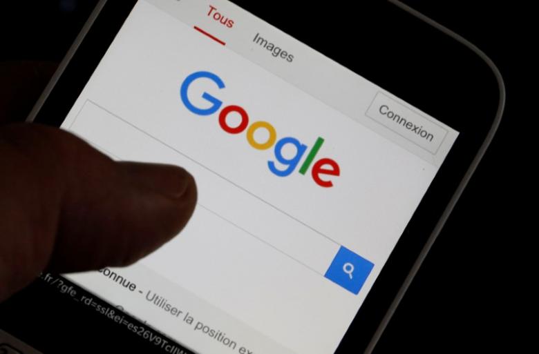 A man holds his smartphone which displays the Google home page, in this picture illustration taken in Bordeaux, Southwestern France, August 22, 2016. REUTERS/Regis Duvignau