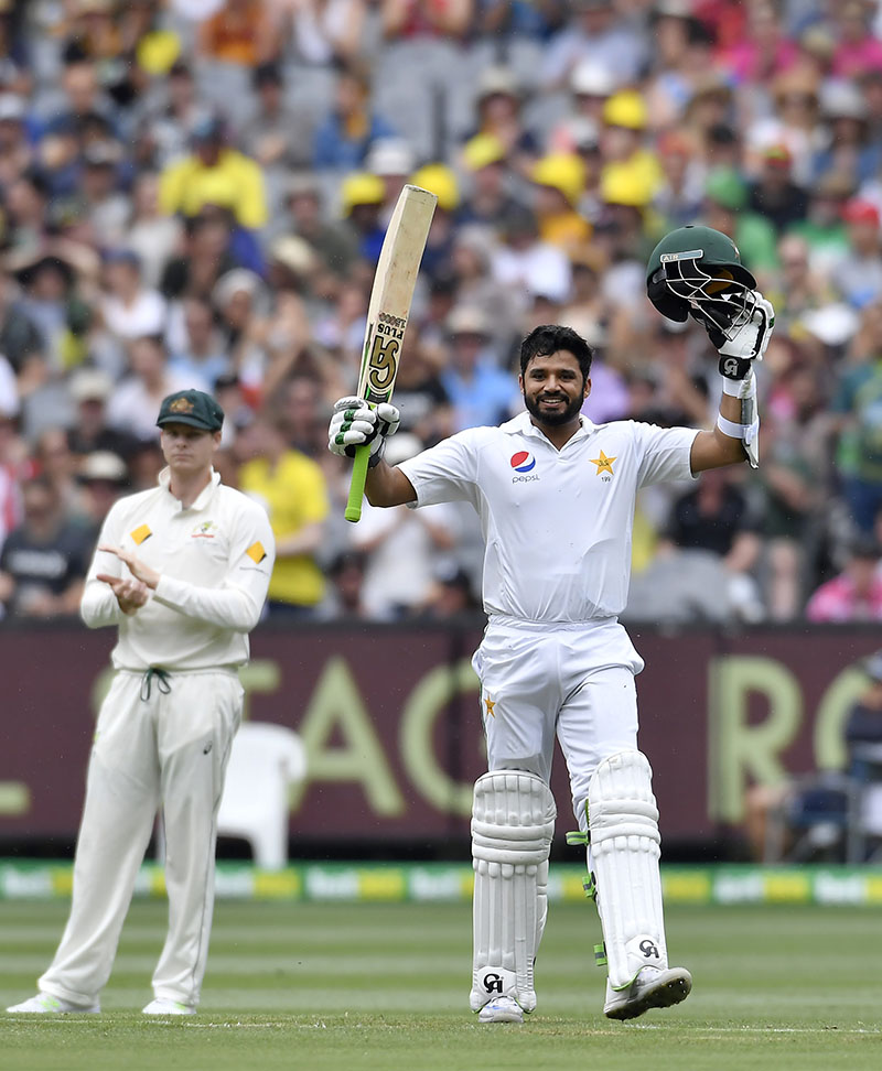 Pakistan's Azhar Ali celebrates scoring a century watched by Australian captain Steve Smith (left) on the second day of their second cricket test match in Melbourne, Australia, on Tuesday, December 27, 2016. Photo: AP