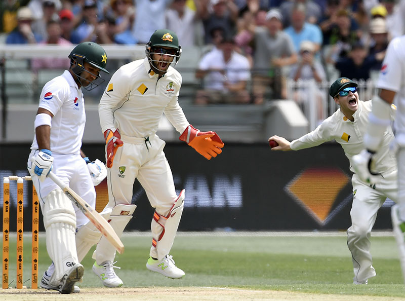 Australian captain Steven Smith (far right), celebrates catching out Pakistan's Sami Aslam (left) off the bowling of Nathan Lyon on the first day of their second cricket test in Melbourne, on Monday, December 26, 2016. Photo: AP