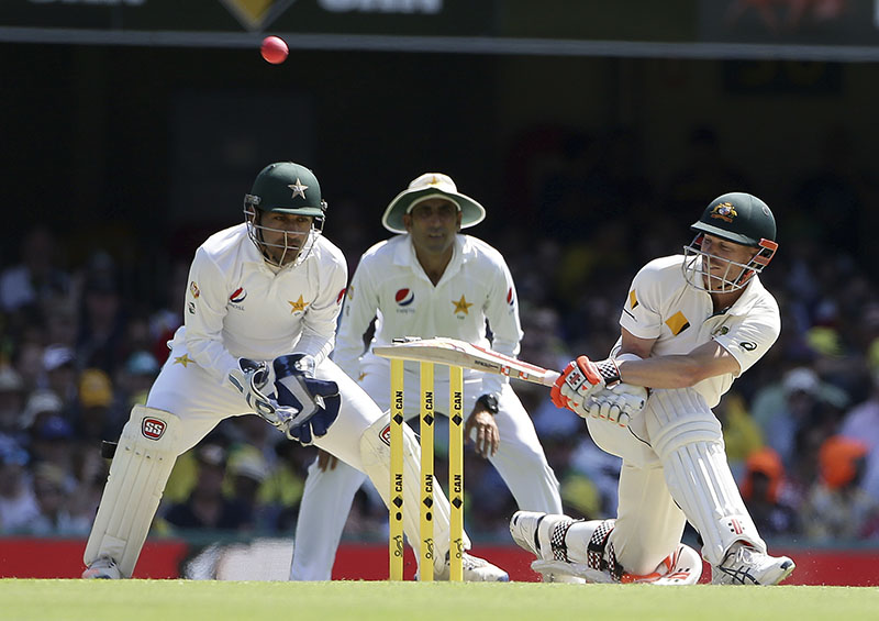 Australian batsman David Warner plays a sweep shot during play on day one of the first cricket test between Australia and Pakistan in Brisbane, Australia, on Thursday, December 15, 2016. Photo: AP