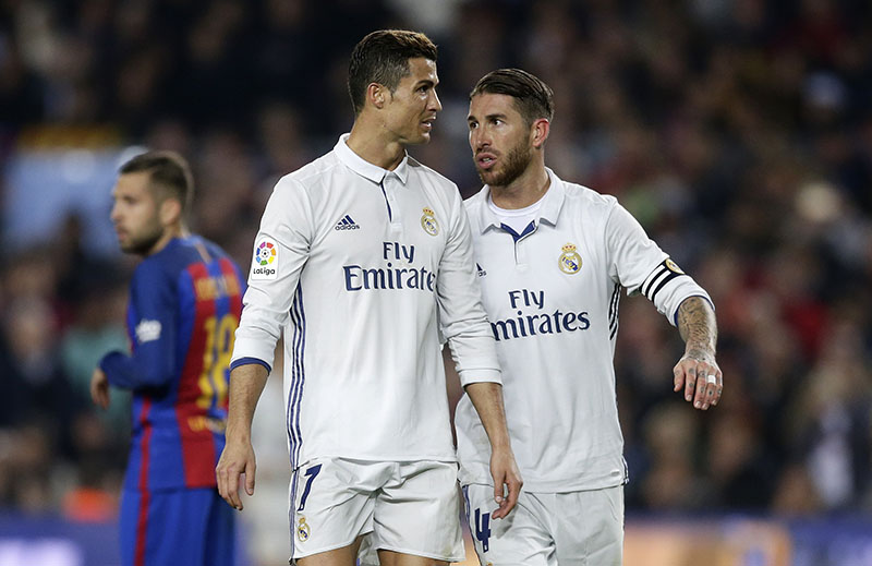 Real Madrid's Sergio Ramos (right) talks with teammate Cristiano Ronaldo during the Spanish La Liga soccer match between FC Barcelona and Real Madrid at the Camp Nou in Barcelona, Spain, on Saturday, December 3, 2016. Photo: AP