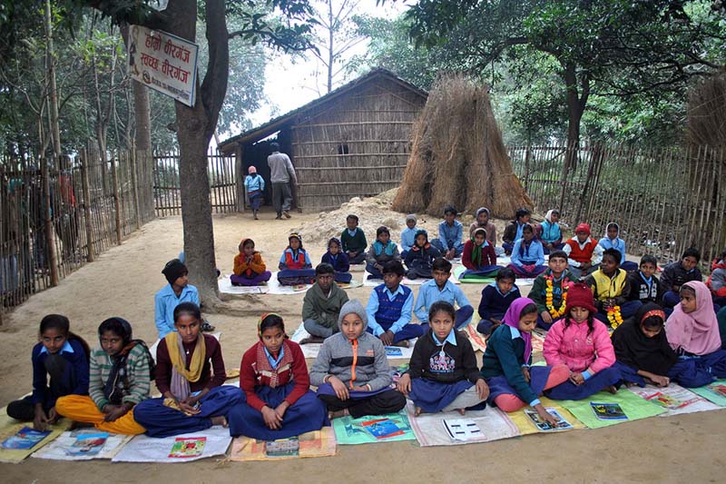 Students of the Loknath Singh Primary School in Udayapur Ghurmi, Birgunj-30 of Parsa district take a class in the sun to beat the chilling winter, on Friday, December 9, 2016. Photo: RSS  