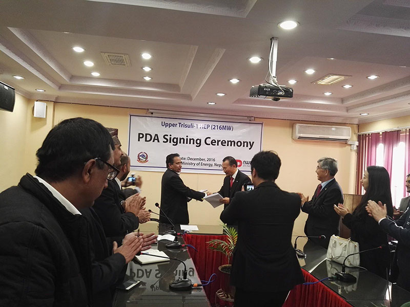 Bo Seukyi, exchanging notes after signing the PDA of the 216 MW Upper Trishuli-1 Hydroelectric Project located in Rasuwa, in Kathmandu, on Thursday, December 29, 2016. Photo: THT