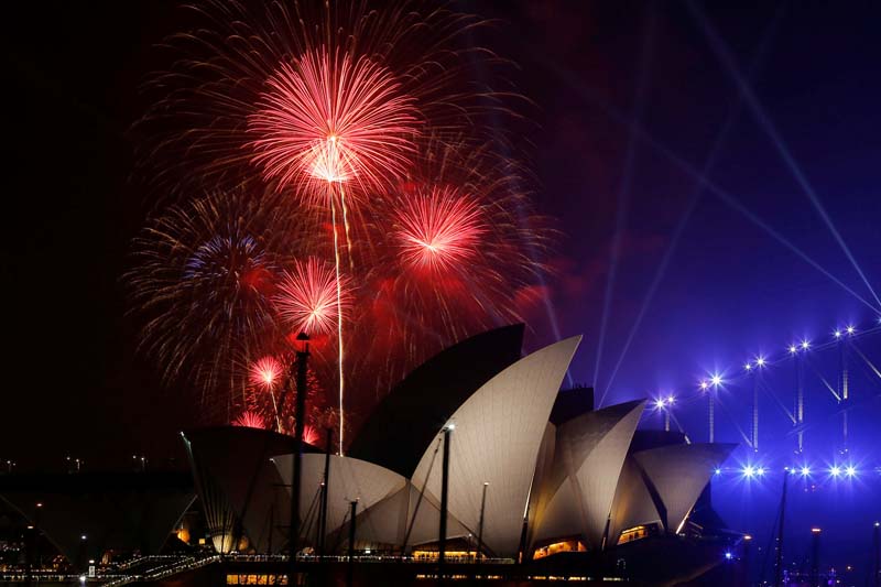 Fireworks explode over the Sydney Opera House during an early evening display in the lead up to the main New Year's Eve fireworks in Sydney, Australia, December 31, 2016. Photo: Reuters