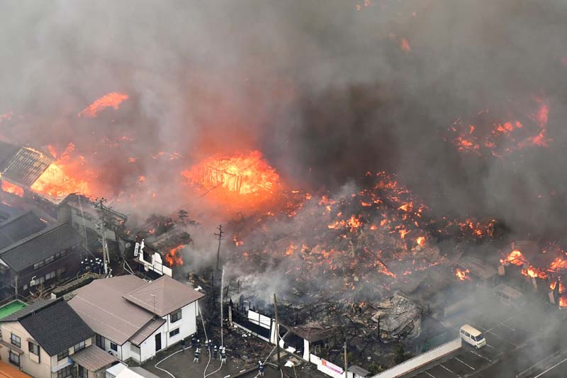 A fire engulfs houses and stores, near JR Itoigawa Station, in Itoigawa, Niigata Prefecture, Japan, on Thursday, December 22, 2016. Photo: Reuters