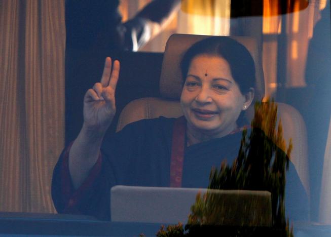 FILE PHOTO - J. Jayalalithaa, chief minister of India's Tamil Nadu state and chief of Anna Dravida Munetra Khazhgam (AIADMK), gestures from inside a vehicle after addressing her party supporters during an election campaign rally in the southern Indian city of Chennai April 19, 2014. REUTERS/Babu/File Photo