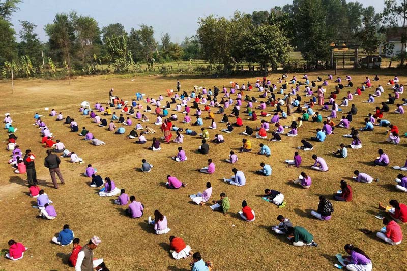 Students of Shree Krishna Secondary School in  Jhalari of Kanchanpur district take their annual examination in the open while basking in the sun, on Wednesday, December 7, 2016. Photo: RSS